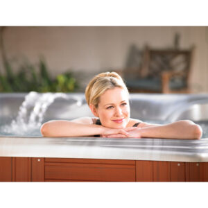 woman resting chin and arms on edge of hot tub