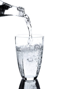 mineral water being porued into a glass