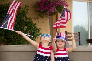 Patriotic sisters celebrate the 4th of July in front of their FreeFlow Spa