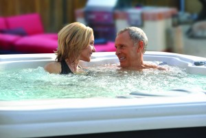 Happy couple soaking in hot tub