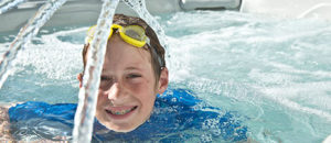 boy smiling in a hot tub