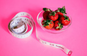 bowl of strawberries and measuring tape