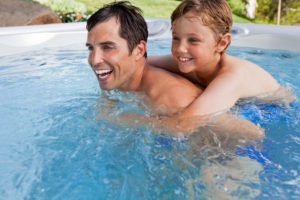 father and son in hot tub