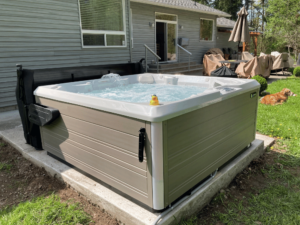 A HotSpring Flash hot tub, with its cover off, in a customer's yard in Renton, Washington.
