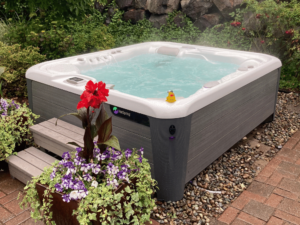 A HotSpring Sovereign hot tub in a lushly planted customer's yard in Newcastle, Washington.